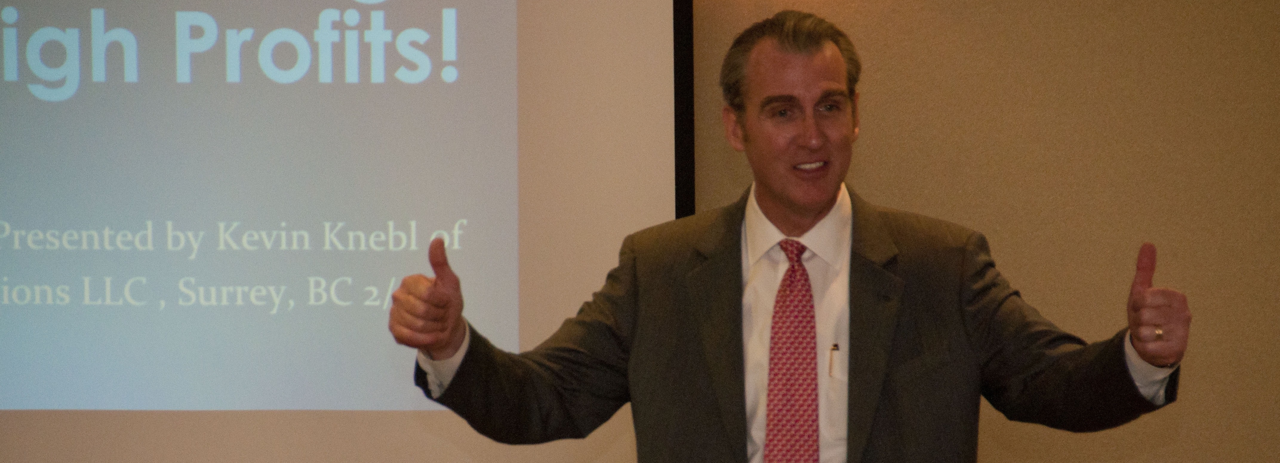 A man in a suit giving a presentation.